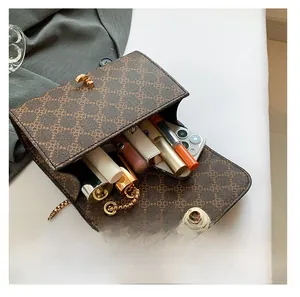 Internal storage view of vintage brown monogram bag showing space for phone and lipsticks