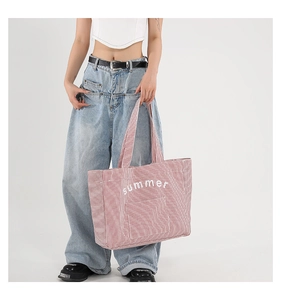 Vue détaillée du sac cabas en toile rayé rouge et blanc avec imprimé Summer porté