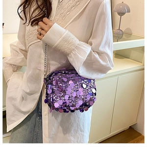 Close-up of sparkling purple sequins and silver chain strap on a stylish crossbody bag