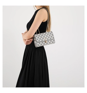 Shoulder bag with grey and white geometric pattern and elegant gold chain strap