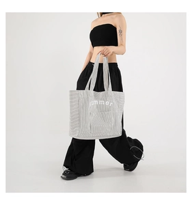 Detail of canvas tote bag with black and white stripes and summer print for women