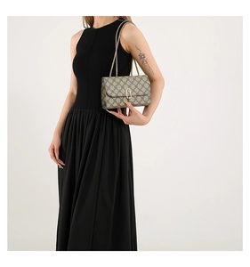 Side view of model wearing a vintage geometric square bag with gold chain strap