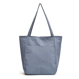 Waterproof nylon tote bag in misty blue with large capacity and a pleated texture