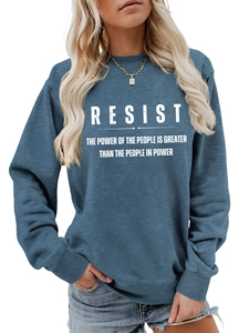 Detail eines blauen Sweatshirts mit weißem RESIST-Schriftzug und Rippbündchen