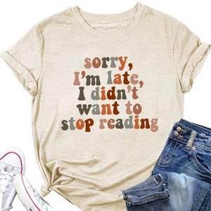 Flat lay of beige cotton T-shirt with 'Sorry I'm late' slogan and side knot detail