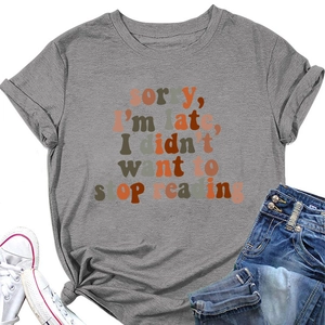 Detail of grey crewneck T-shirt with 'Sorry I'm late' slogan tied at the hem