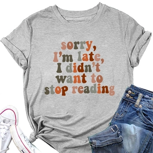 Flat lay of a grey round neck T-shirt with 'Sorry I'm Late' print and casual jeans