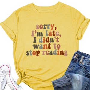 Detail of ginger yellow t-shirt with sorry i'm late i didn't want to stop reading print