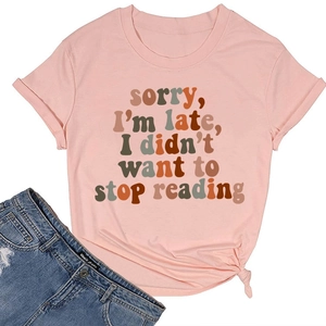 Flat lay of pink cotton T-shirt with reading quote and blue denim shorts for summer
