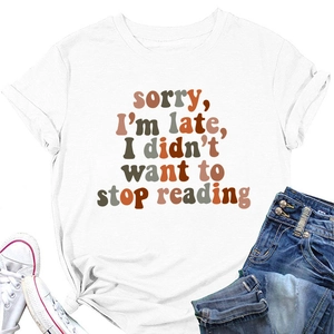 Flat lay of white cotton T-shirt with 'sorry I'm late' slogan and denim jeans