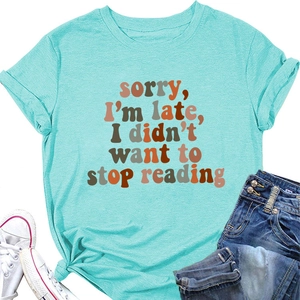 Detail of light blue cotton T-shirt featuring sorry I'm late print and trendy knotted hem