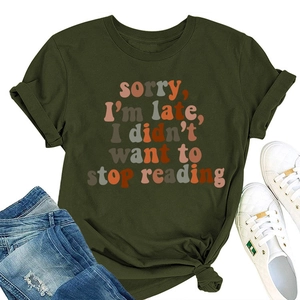 Flat lay of olive green cotton T-shirt with 'Sorry I'm Late' slogan and denim jeans