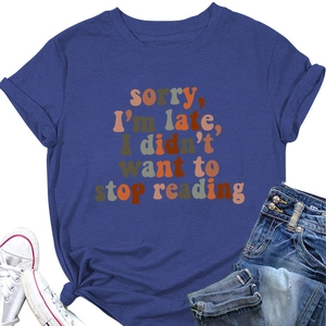 Flat lay of navy blue round neck T-shirt with 'Sorry I'm Late' book lover quote