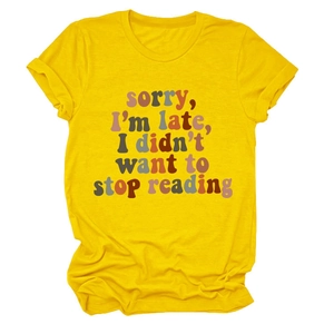 Detailed knit texture of yellow t-shirt with sorry i'm late i didn't want to stop reading print
