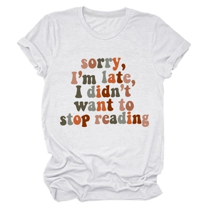 Detail of white cotton t-shirt with 'sorry I'm late I didn't want to stop reading' print