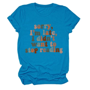 Detail of artistic 'Sorry I'm Late' colorful text print on blue cotton T-shirt