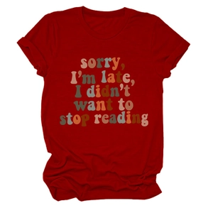 Detail of red crewneck T-shirt with 'sorry I'm late I didn't want to stop reading' print
