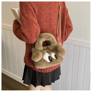 Sac à bandoulière en peluche marron avec broderie de grands yeux porté par un mannequin
