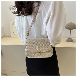 Minimalist straw crossbody bag with green floral embroidery and gold metal clasp