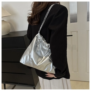 Silver metallic pleated drawstring tote bag with chain strap and bow details