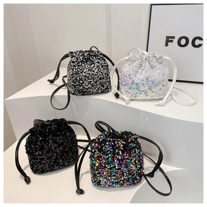 Detailed showcase of sequined bucket bags in black, white, and multi-color on geometric stands
