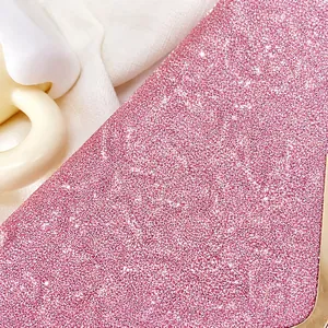 Macro shot of pink glitter texture and gold metal frame on a stylish evening clutch bag