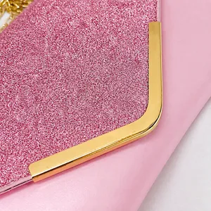 Detailed close-up of pink sequin clutch featuring gold-tone metal frame and hardware
