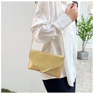 Detailed close-up of champagne gold sequined V-shaped flap evening clutch bag with chain