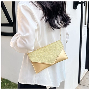 Close-up of golden sequin evening clutch bag with elegant metal chain shoulder strap