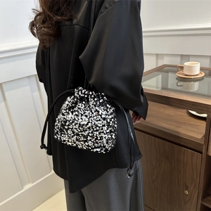 Fashionable sequined drawstring bucket bag with silver and black sparkles for elegant look