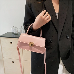 Pink minimalist crossbody bag with golden square lock and top handle for women