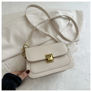 Detail view of cream white leather square bag with vintage gold metal buckle closure