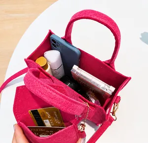 Top view showing the internal capacity and daily essentials inside the rose red felt tote