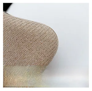 Macro shot of glittery champagne gold fabric texture with metallic edge on clutch bag