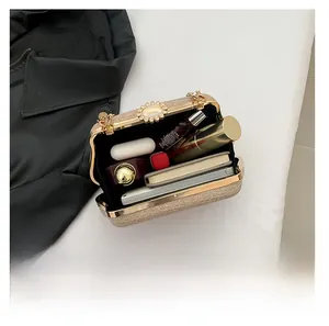 Detail view showing large interior capacity of sequined evening bag with chain strap
