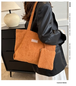 Detail showing bright orange corduroy tote bag and matching pouch with fashion tag