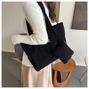 Detail of black corduroy tote bag with vertical stripes and matching coin purse