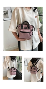 Detail view of pink canvas multi-use bag showing Sport tag, zip pockets and black straps