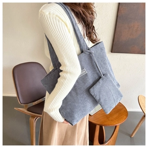 Detail of grey blue corduroy tote bag with vertical stripes and matching zipper pouch