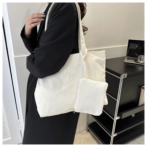 Detailed view of white corduroy tote bag set with fashion label and small coin pouch