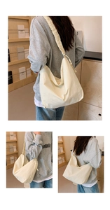 Detail of cream drawstring nylon shoulder bag featuring pleated texture and wide strap