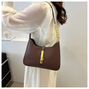 Detail of dark brown retro shoulder bag featuring a sleek gold chain and rectangle clasp