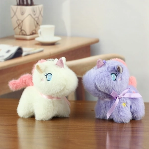Macro detail of plush unicorn pendants with satin bows and star embroidery on wood