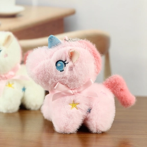 Detailed close-up of plush unicorn charms with blue sequin horns and embroidered stars