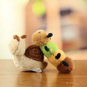 Macro shot of plush snail and colorful caterpillar toys showing soft texture and stitching