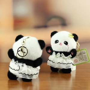 Close-up of cute panda plushies in white tutus showing both front and back keychain details