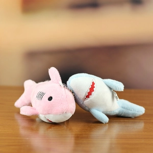 Detail of cute pink and blue plush shark keychains with fine embroidery and metal chains