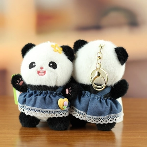 Front and back detail of panda plush charms in blue lace skirts with metal keychains