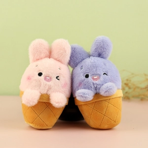 Detail of plush rabbit ice cream pendants featuring pink and purple embroidered faces