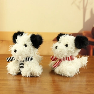 Plush West Highland White Terrier toys with striped scarves on a wooden table